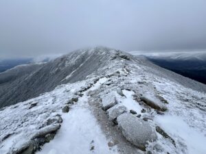 Photograph by Dustin Hilt: Hiker en route to Mount Lincoln in January 2024